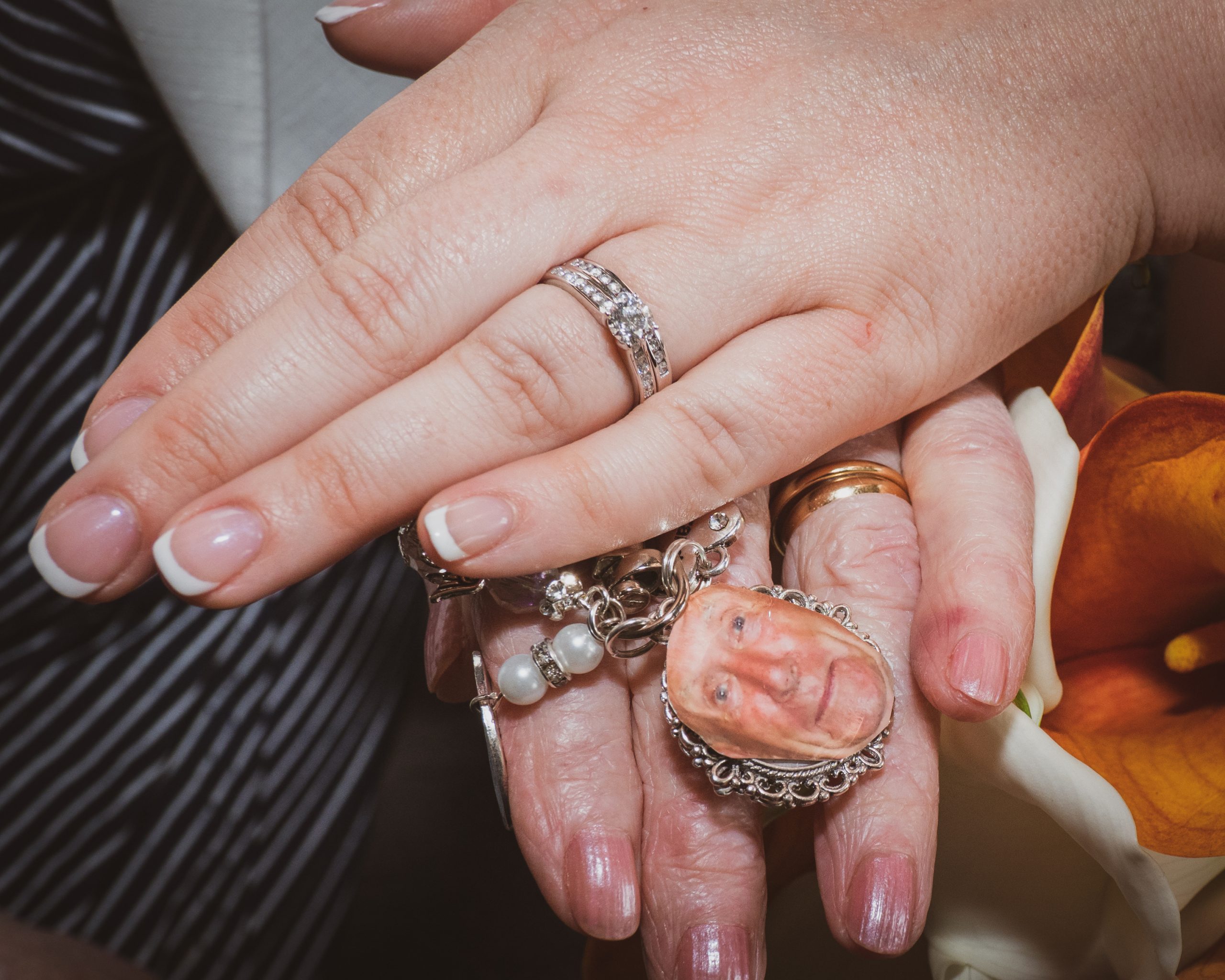 Close-up of Bridal Hands, with Beautiful French Polish Holding a Keyring of Her Dear Granddad