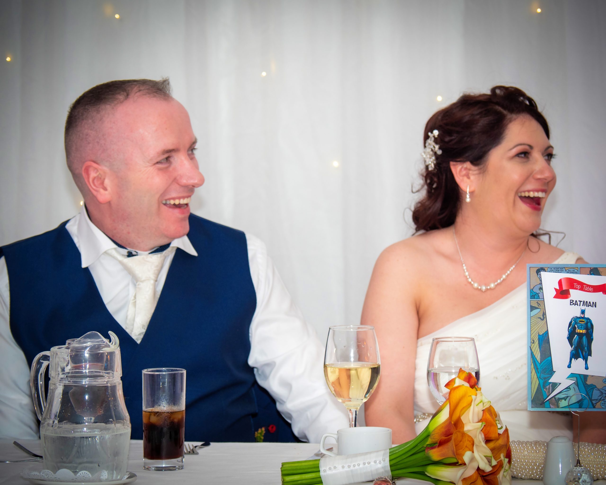 The happy couple share a laugh together during the Best Man's speech!